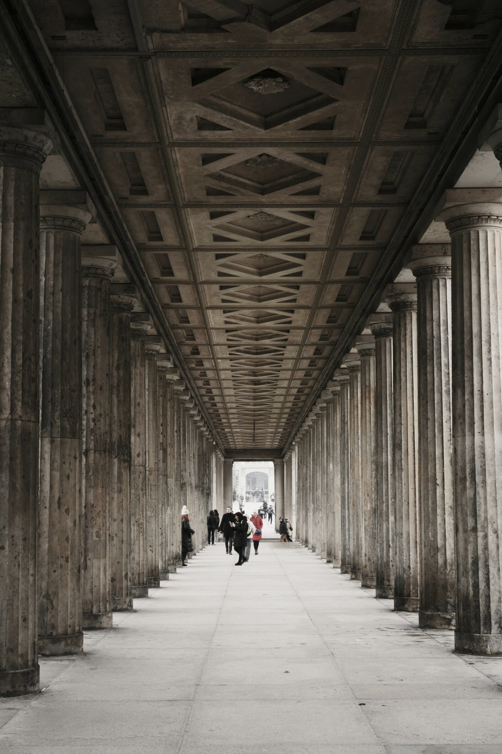 Visitors walking through the James Simon Galerie colonnade on Museum Island.